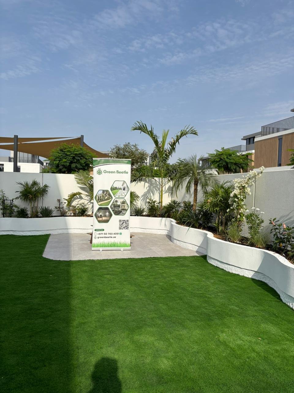 Completed landscape design project with lawn and palm trees